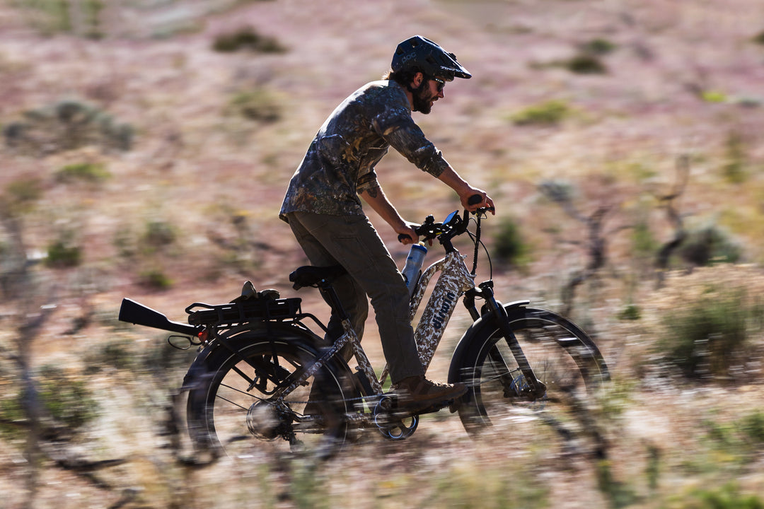 Standup riding the Dirwin Pioneer Plus Fat Tire Electric Bike With Hydraulic Disk Brakes, Headlight, Brake Light, and Utility Rack For Off Road, Hunting, Fishing, and More