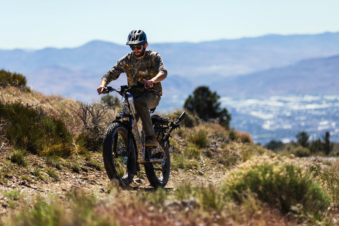 Action shot of riding the Dirwin Pioneer Plus Fat Tire Electric Bike With Hydraulic Disk Brakes, Headlight, Brake Light, and Utility Rack For Off Road, Hunting, Fishing, and More