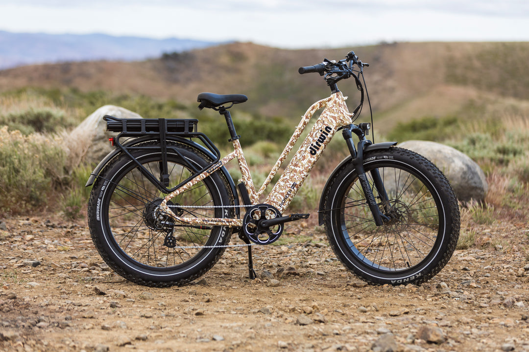 Dirwin Pioneer Plus Fat Tire Electric Bike offroad desert camouflage with a desert landscape background
